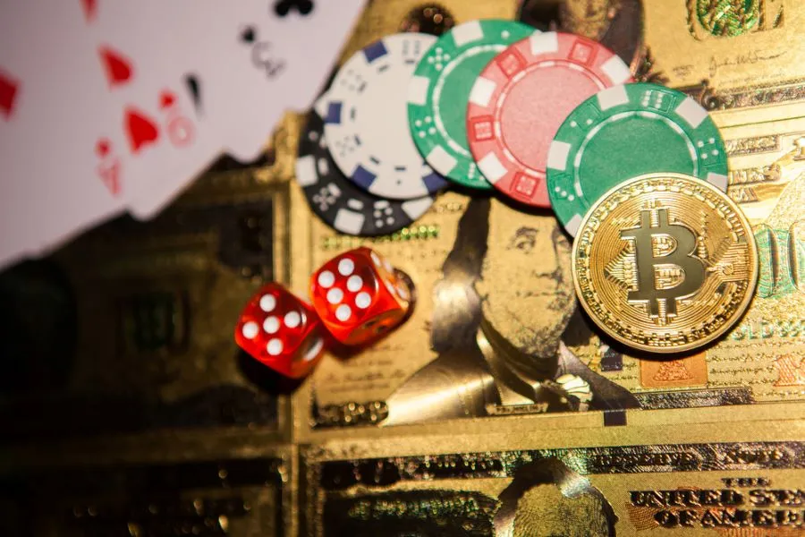 bitcoin with dollar bills and casino chips
